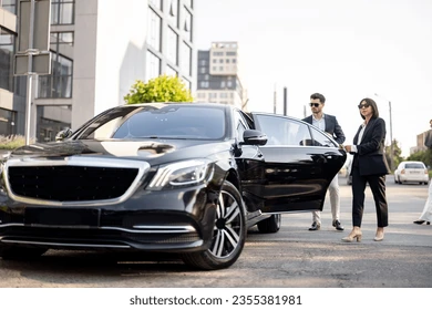 ADS Dispatch Services female chauffeur helps business man 260nw 2355381981